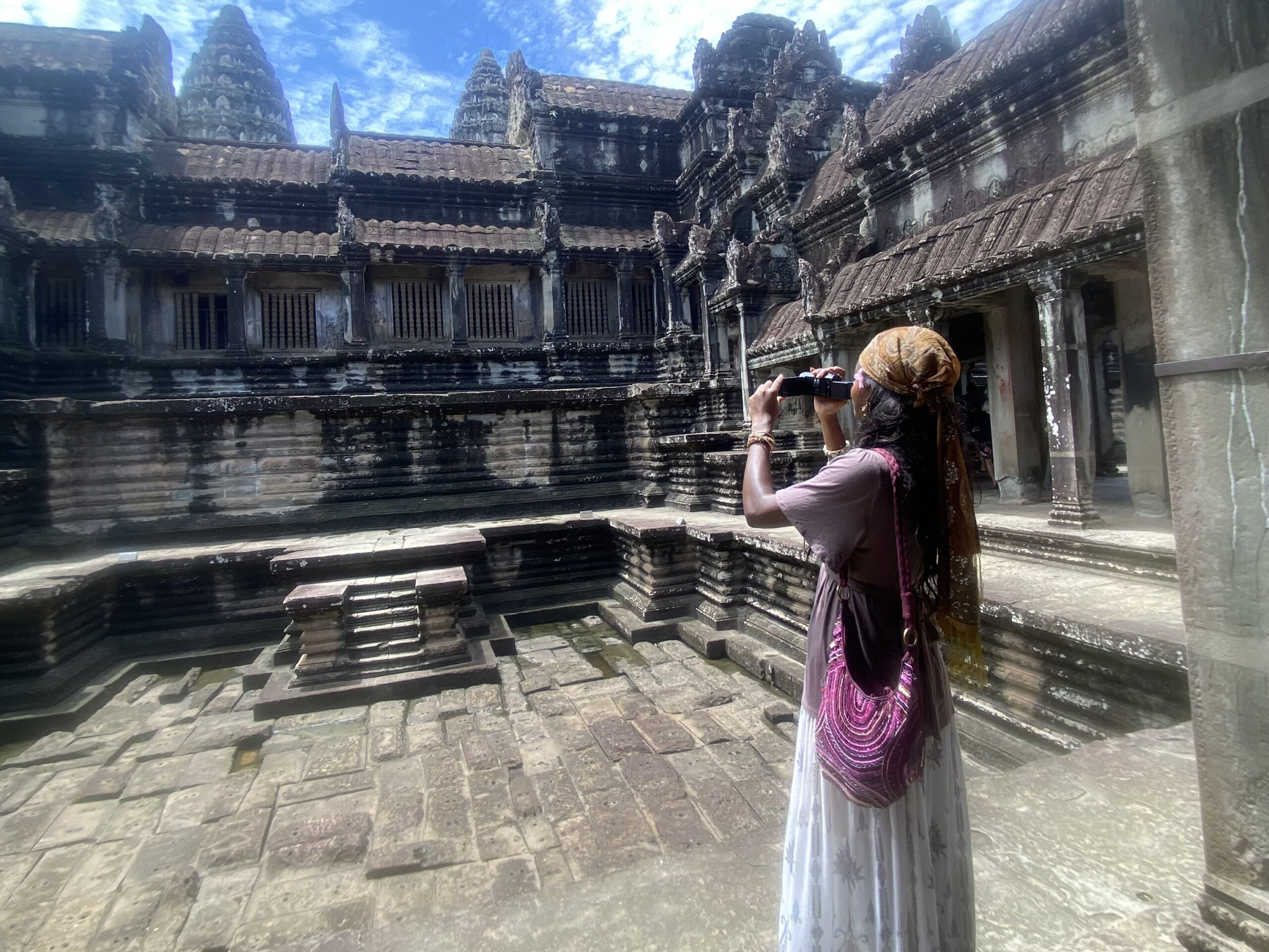 Solo traveler taking a photo at Angkor Wat while wearing boho-style clothing — introducing my travel blog about exploring culture, history, and style across Asia