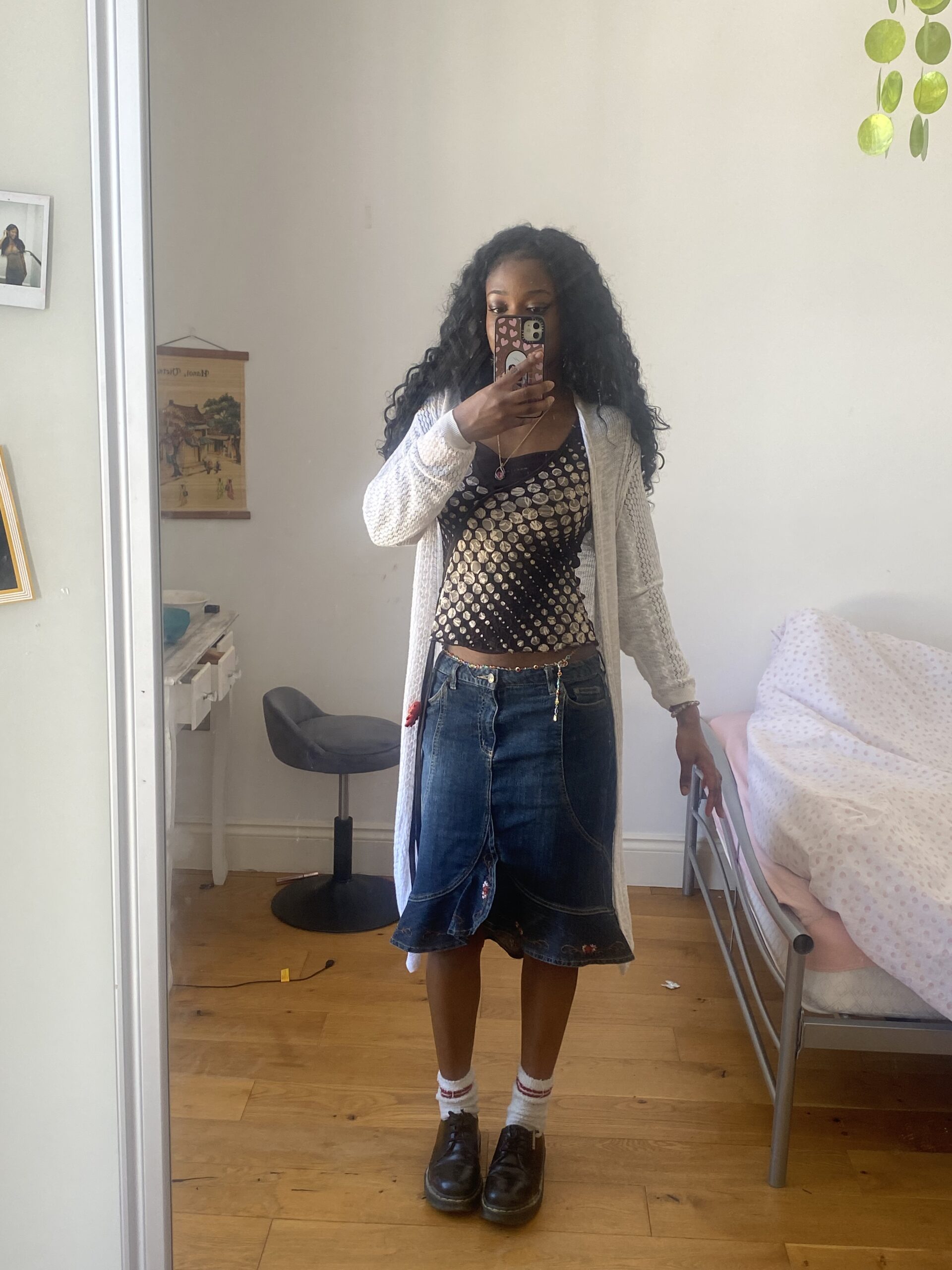 How to actually develop your personal style part 2 intage-inspired outfit featuring a long denim skirt, brown spotted top, white long cardigan, and Doc Martens with long socks