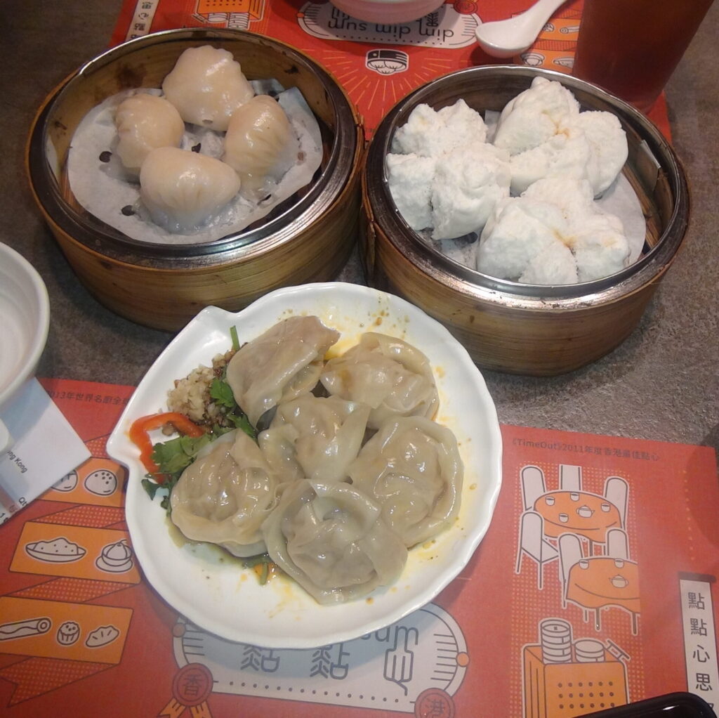 restaurant table displaying three freshly steamed dim sum dishes, highlighting authentic Hong Kong food experiences featured in a study-abroad blog post about life and culture at HKU