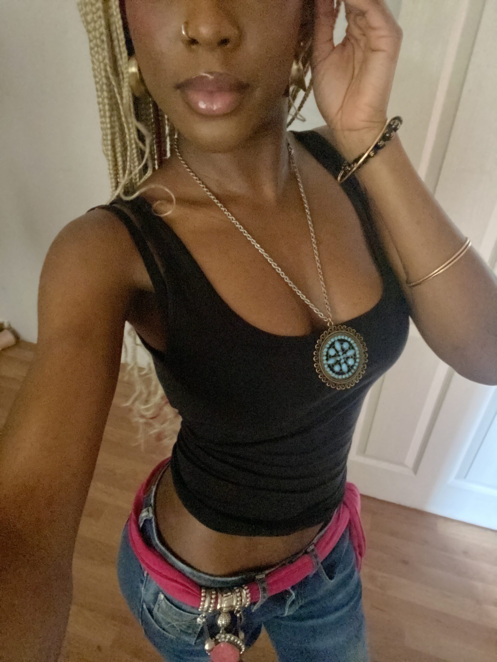 How to actually develop your personal style part 2 Y2K-inspired outfit with flare jeans, a pink scarf belt, and a black cropped vest showcasing my playful early-2000s fashion aesthetic.