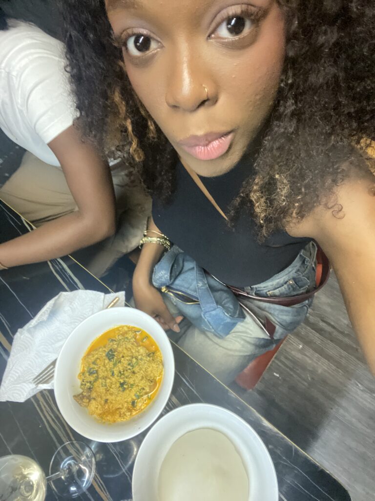 Photo of a Black student eating poundo and egusi soup in Tsim Sha Tsui, Hong Kong, highlighting cultural food experiences while studying abroad