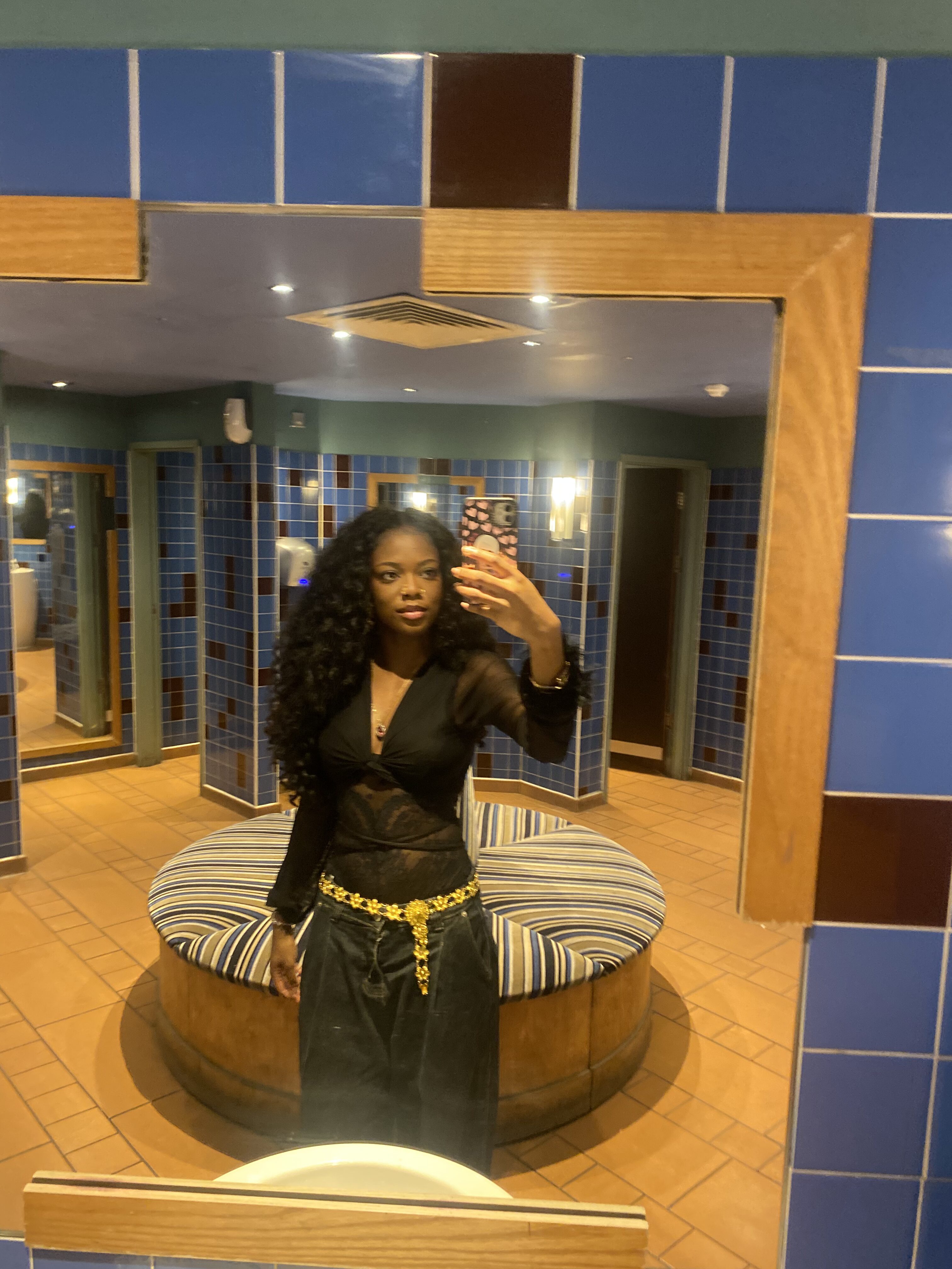 How to actually develop your personal style part 2 Chic layered outfit with baggy straight-leg pleated jeans, a lace bodysuit, black wrap top, and a gold flower waist chain