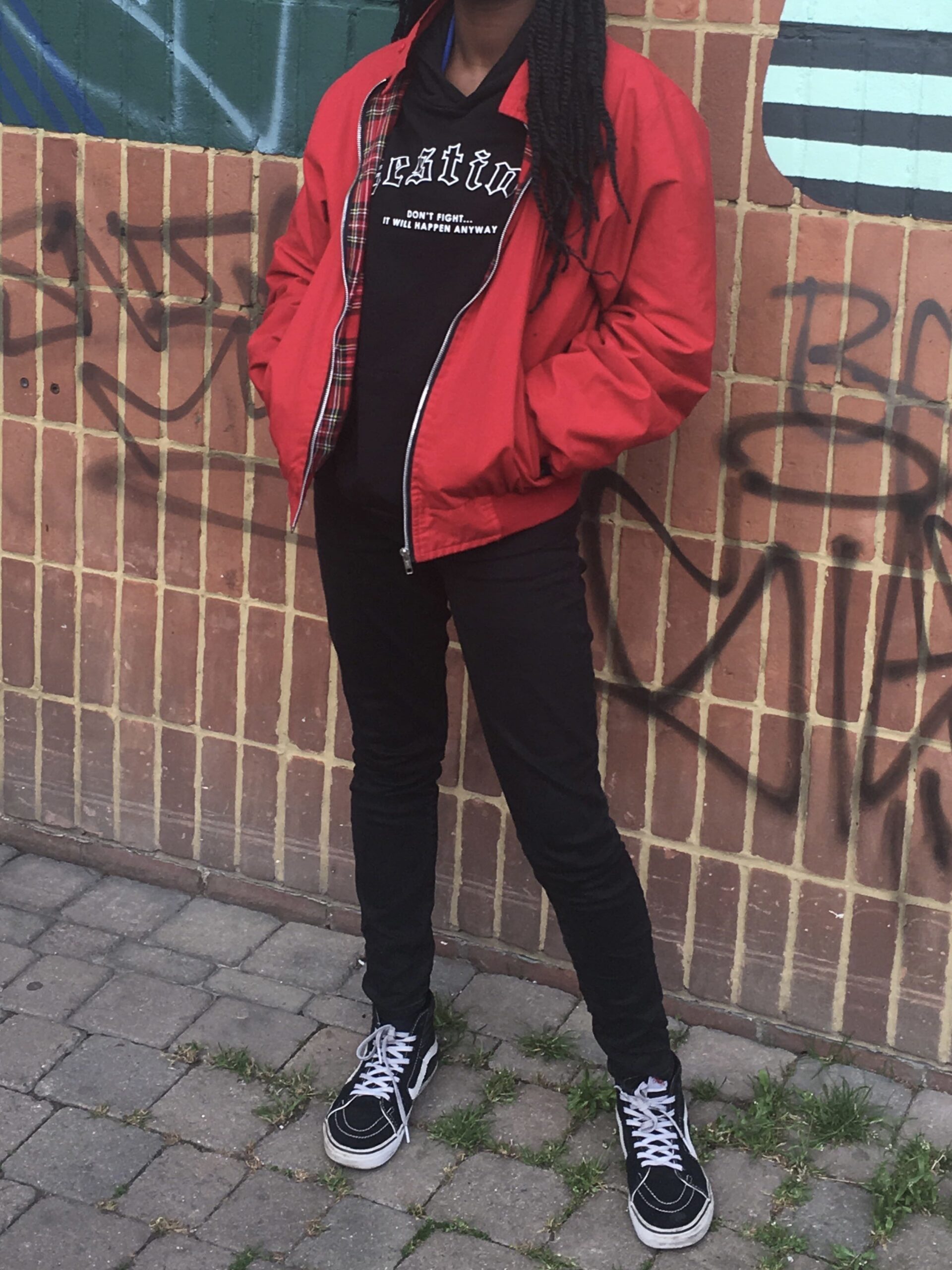How to actually develop a personal style Photo of me in a red Ralph Lauren jacket layered over a black hoodie with black jeans and Vans, representing a sporty, casual chapter in my personal style journey centered on timeless streetwear basics.