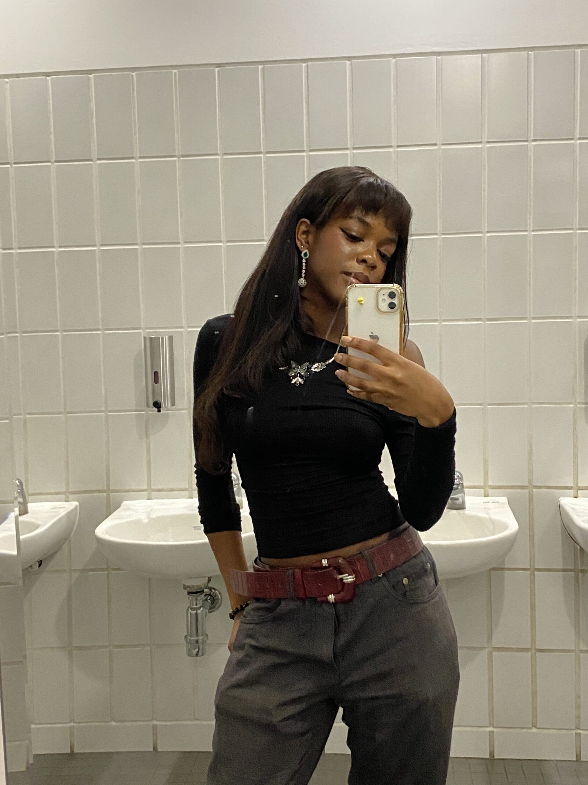 How to actually develop your personal style part 2 Elegant outfit with grey trousers, a burgundy belt, and an off-the-shoulder black top reflecting my refined and minimalist style