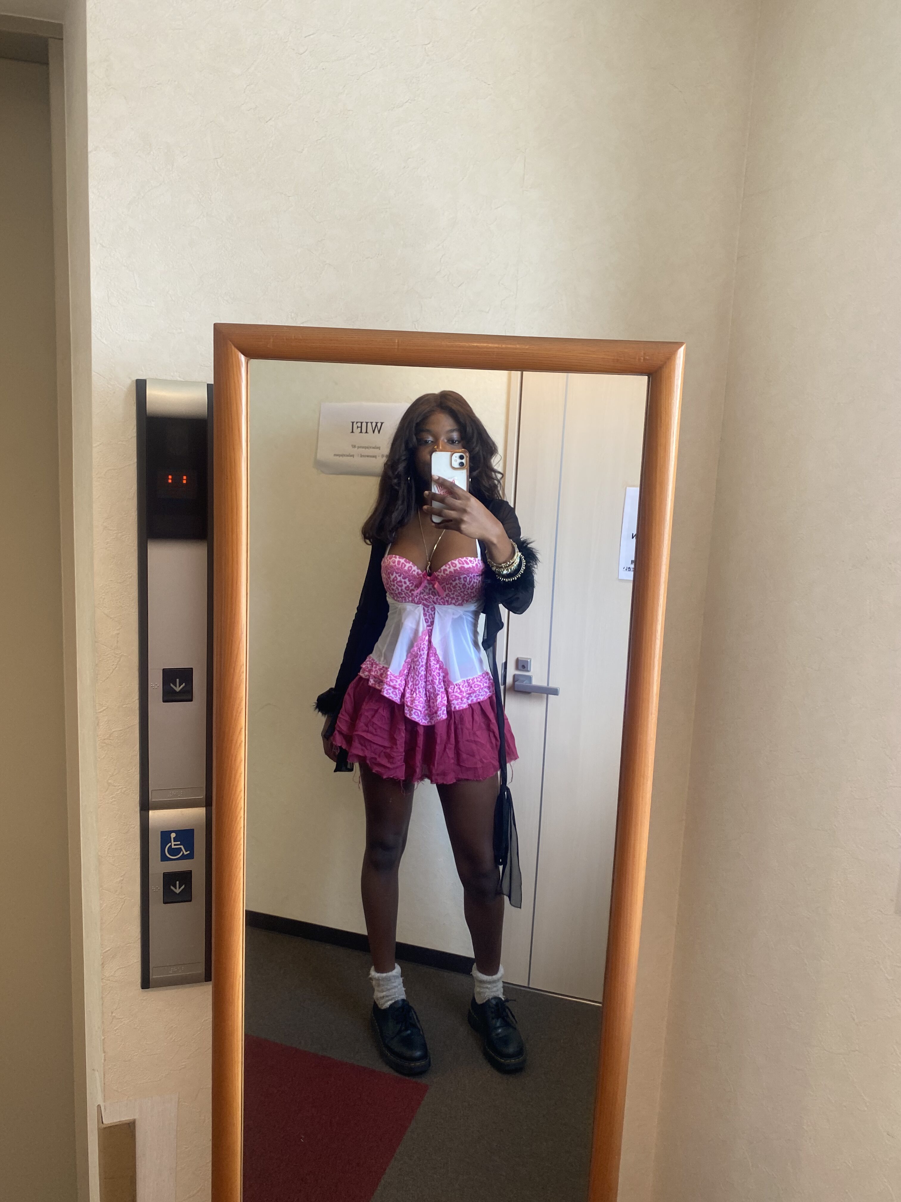 How to actually develop your personal style part 2 Playful feminine outfit with a flowy pink mini skirt, white and pink leopard print top, black lace cardigan, and Doc Martens with white socks